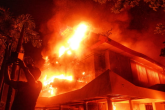 Council building ablaze during protests in Makassar, Indonesia (Image credit: The Guardian)